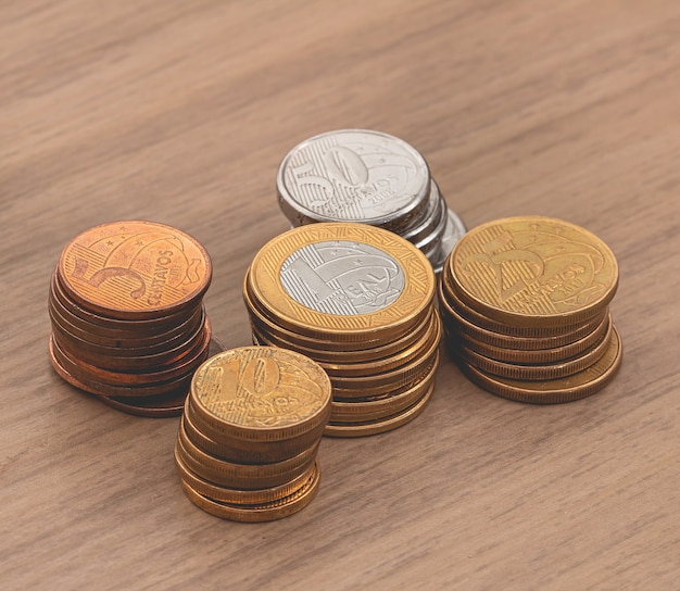 Real brl Brazilian coins on a wooden furniture with a view from the top