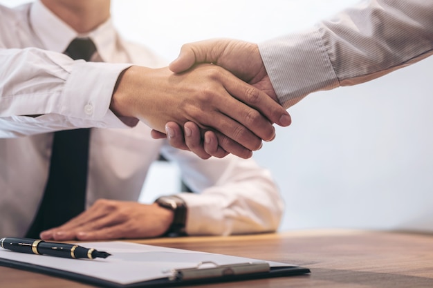 Real estate agent and customer shaking hands