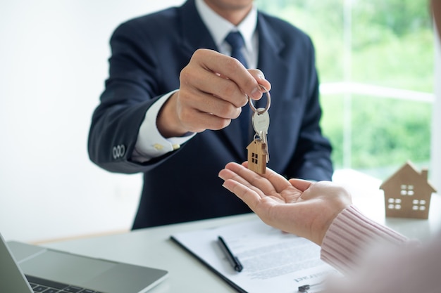 Real estate agent gives key to house