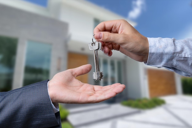 The real estate agent gives the keys to the meeting after the signing of the lease