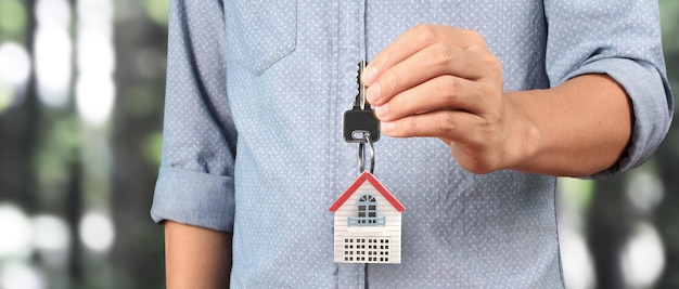 Real estate agent handing over house keys in hand