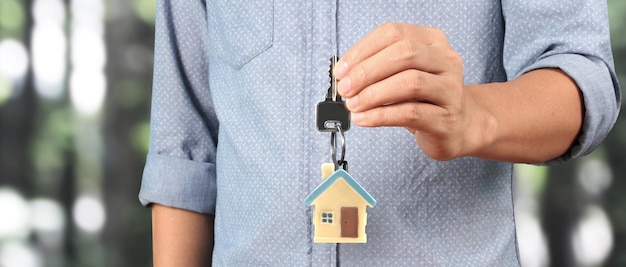 Real estate agent handing over house keys in hand