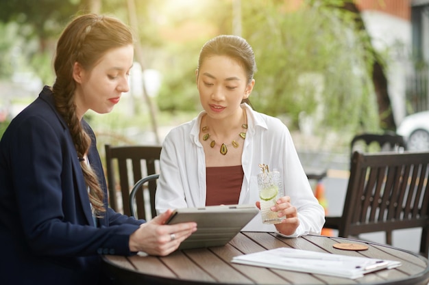 Real estate agent showing client photo of new apartment on tablet computer