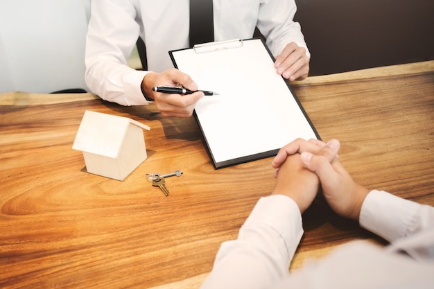 Photo real estate agent showing a contract signature with customer to making a valuation deal