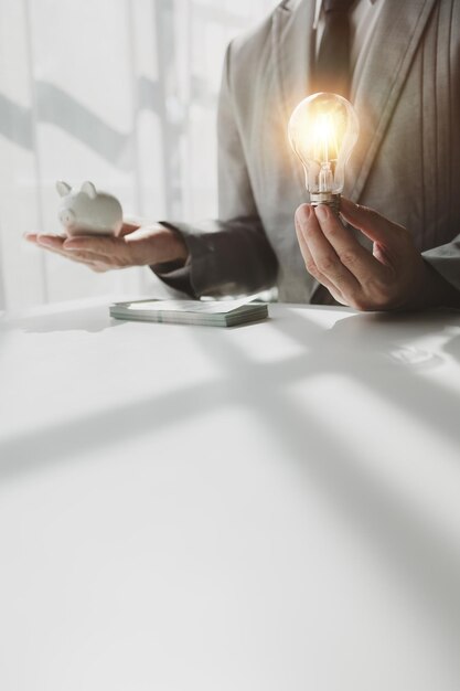 A real estate agent sits in his office A business owner is counting money and making notes in a financial book The financier is verifying the income received from the clients investment