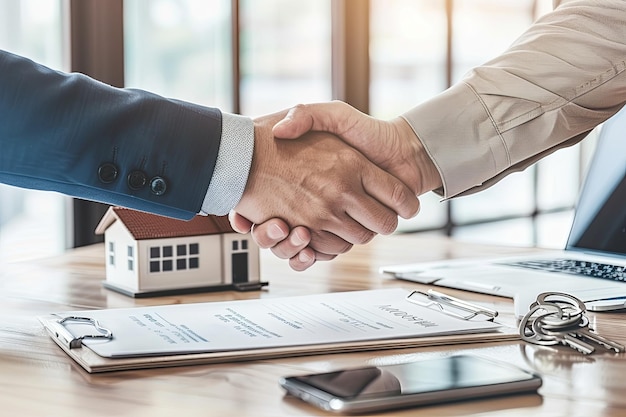 Photo real estate agents and clients shake hands after signing a house purchase agreement