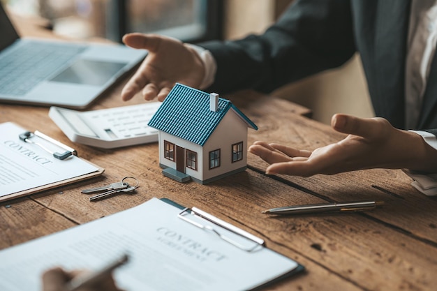 Real estate agents explain models of housing estates in projects to elaborate to clients explaining and presenting information about homes and purchasing loans Real estate trading concept