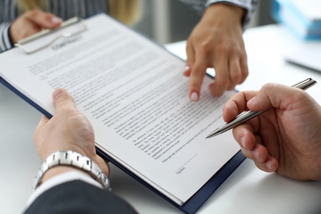 Real estate clerk offering visitor document to sign