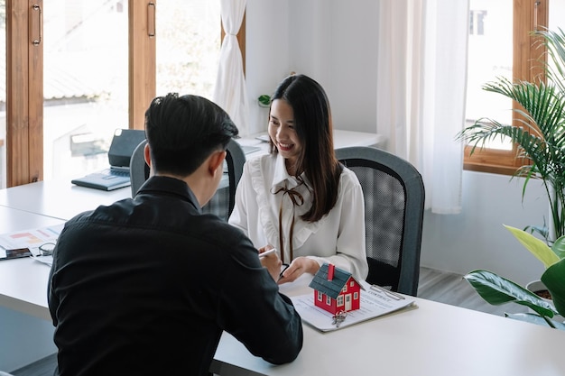 Real estate company to buy houses and land are delivering keys and houses to customers after agreeing to make a home purchase agreement and make a loan agreement Discussion with a real estate agent