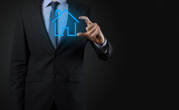 Real estate concept, businessman holding a house icon.House on Hand.Property insurance and security concept. Protecting gesture of man and symbol of house.