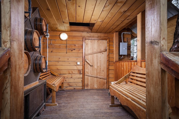 A real Russian bath A room in front of the entrance to the bathhouse with several benches and barrels in the wall