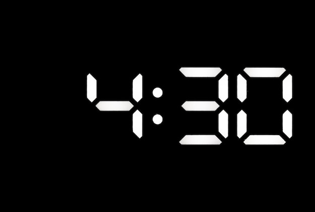 Real white led digital clock on black background