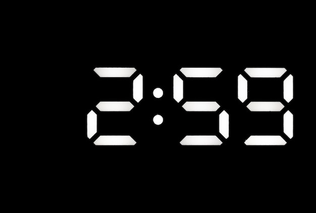 Real white led digital clock on black background