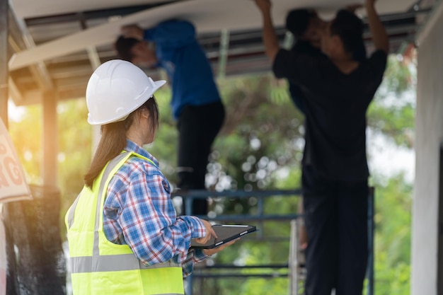 Real working engineering Worker or engineering checking blueprint and planning to renovation Female foreman in safety helmet and study blueprint for redecorating house