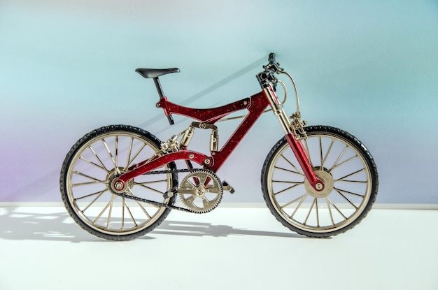 Realistic model of toy metal fullsuspension mountain bike Miniature bicycle on colored background