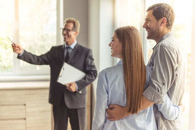 Realtor in classic suit and eyeglasses is holding a notepad