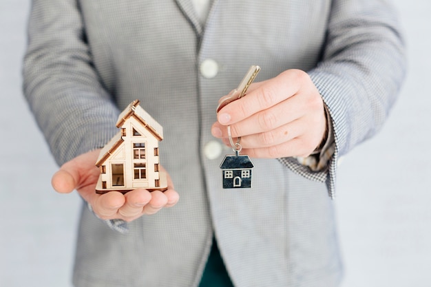 Realtor with key and small house