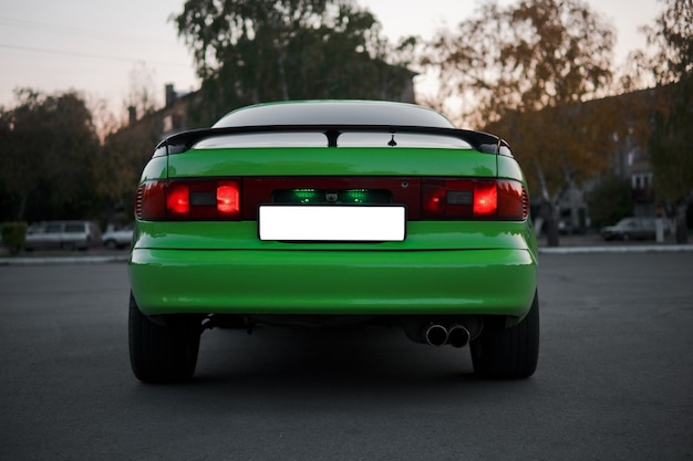 Rear end of green and black sport car. Japanese oldtimer.