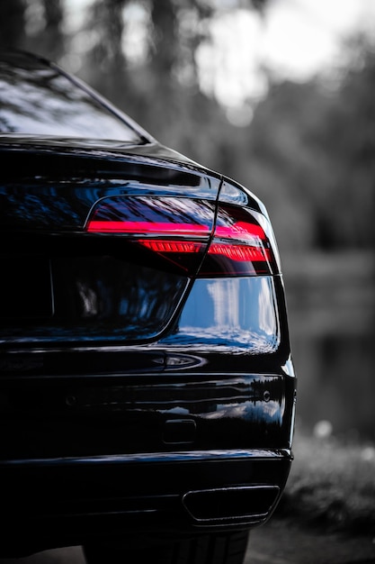 Rear light of a modern black car. Detail of car. Concept of expensive, sports auto.