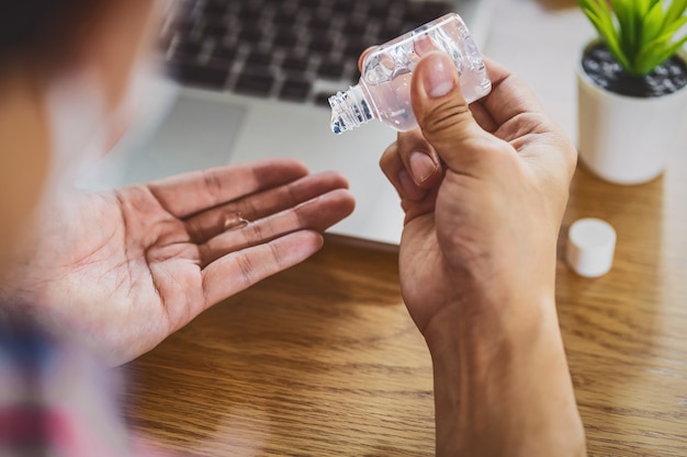 Rear view of Asian man using hand sanitizer by alcohol gel and washing before start to work