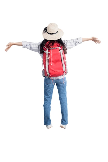 Rear view of Asian woman with hat and backpack standing with open arms