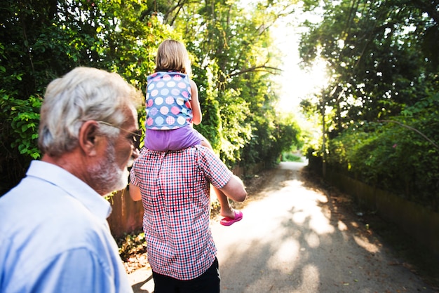 Rear view of caucasian family walking outdoors together