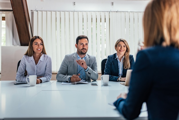 Rear view of female person having a job interview.