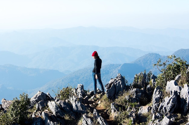 Rear view of man standing on mountain against sky