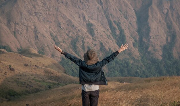 Rear view of man standing on mountain