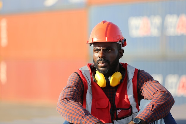 Rear view of man wearing hat while standing in factory