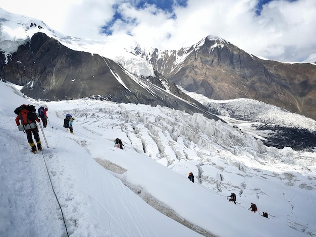 Rear view of people walking on snow covered landscape