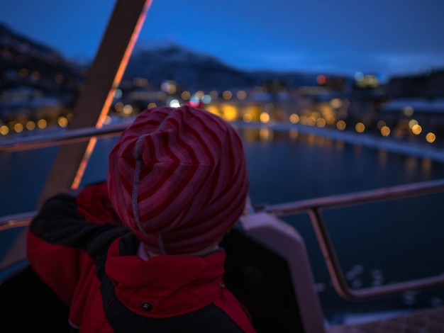 Photo rear view of person sitting in boat at dusk