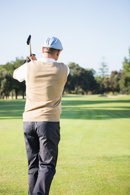 Rear view of sportswoman playing golf