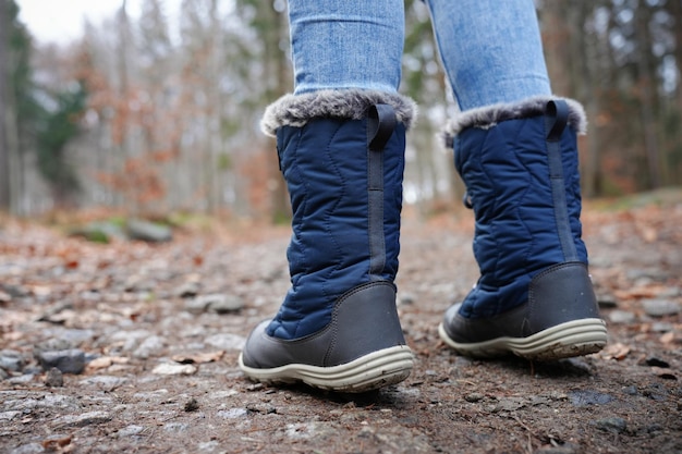 Rear view of traveler in hiking boot on the ground outdoors activity