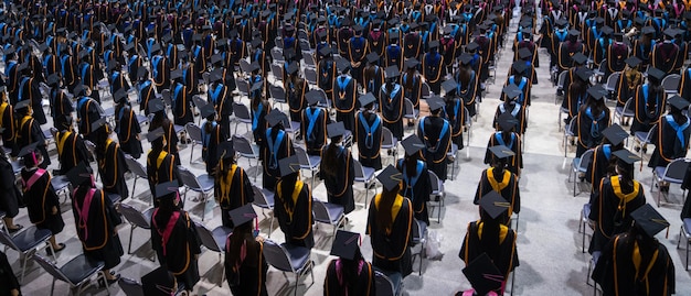 Rear view of the university graduates in graduation gowns and caps