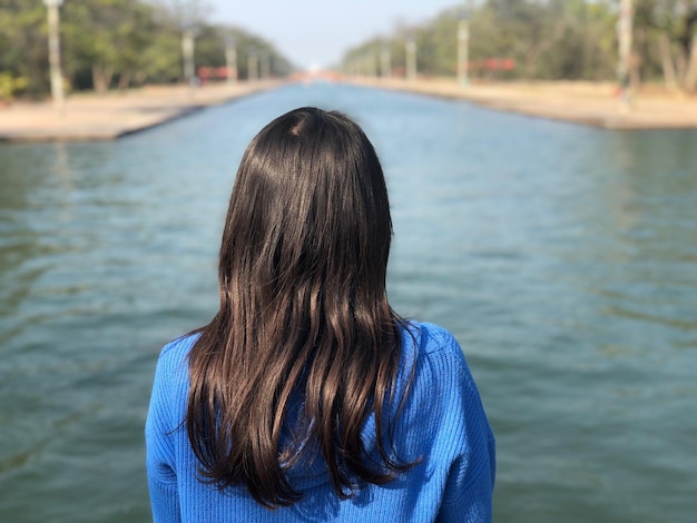 Rear view of woman looking at river