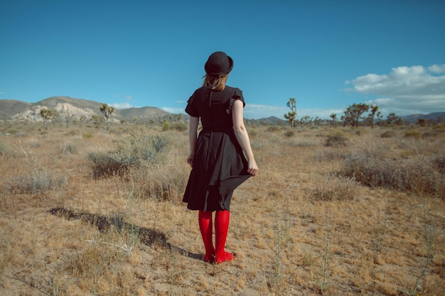 Rear view of woman standing on field