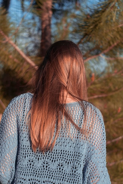 Rear view of woman with hair against trees