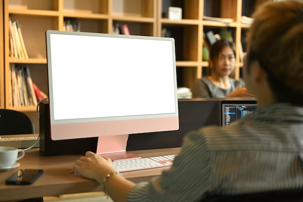 Rear view of young male software developers working for developing new software in corporate office