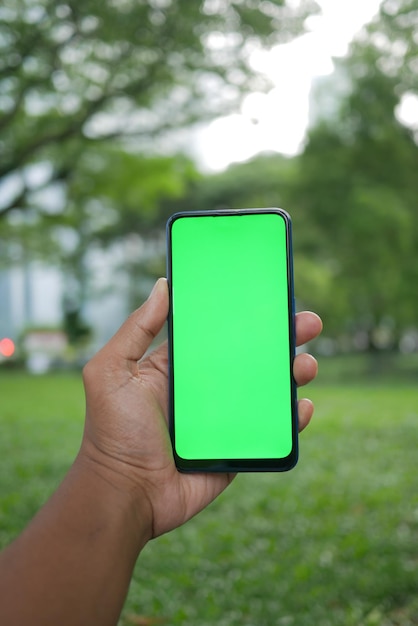 Rear view of young man using smart phone at outdoor