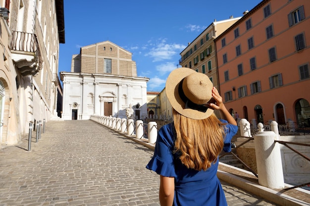 Rear view of young woman walking in Piazza del Plebiscito square in Ancona Marche Italy