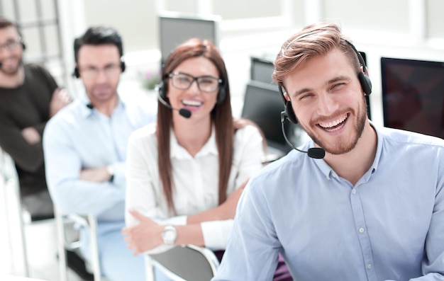 Photo rear viewemployees of the call center looking at the camerabusiness concept