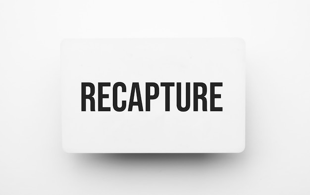 Recapture sign on notepad on the white backgound