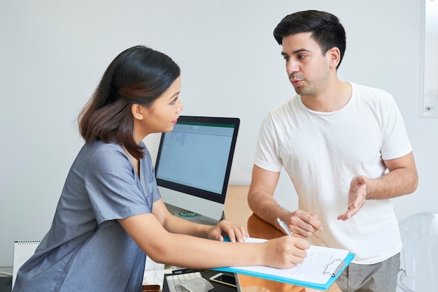 Receptionist working with client