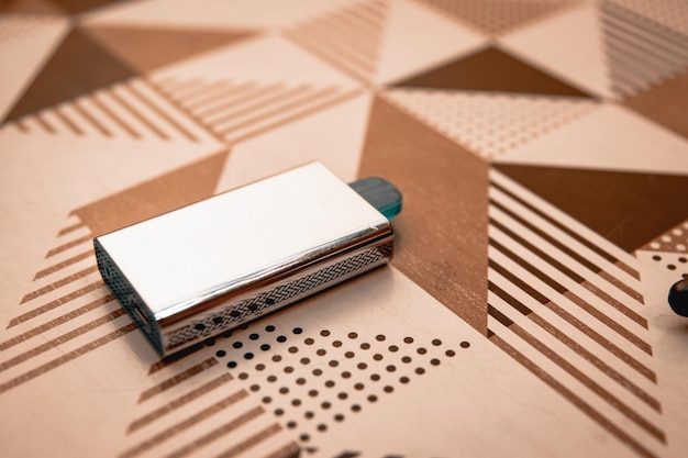 Rechargeable pod on top of a wooden table with designs