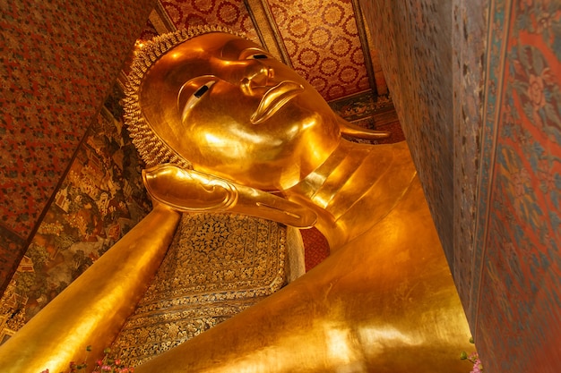 Reclining Buddha gold statue face. Wat Pho, Bangkok, Thailand