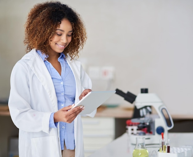 Recording the results Cropped shot of an attractive young woman capturing data on her tablet in the lab