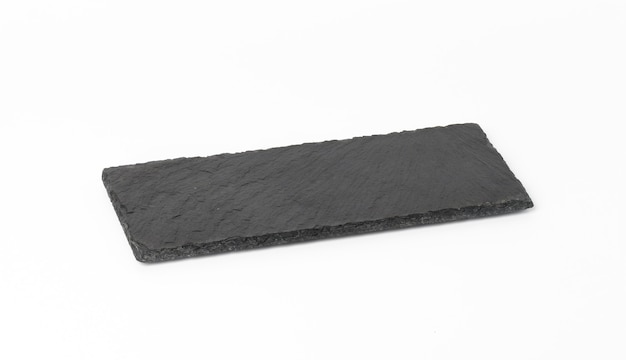 Rectangular black slate stone board isolated on white background, utensils for serving food