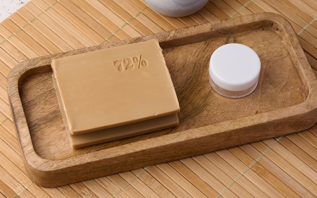 Rectangular brown laundry bar of soap on a wooden background top view