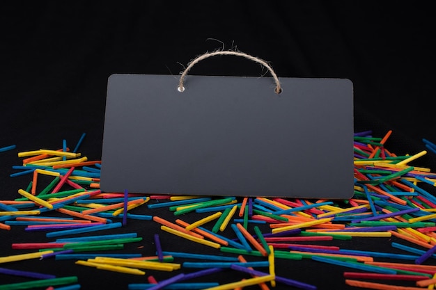 Rectangular shaped black notice board on colorful sticks